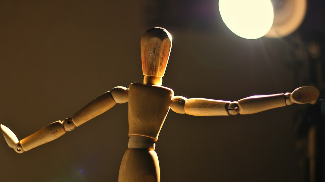 a wooden toy standing in front of a light