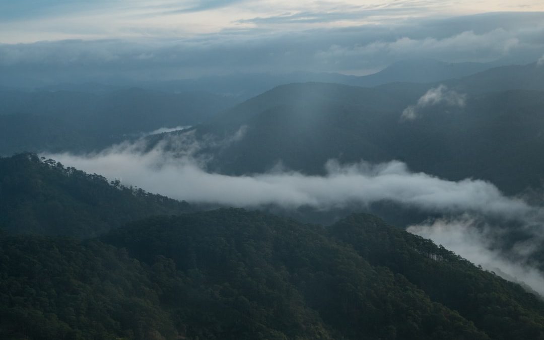 a view of a mountain range covered in clouds