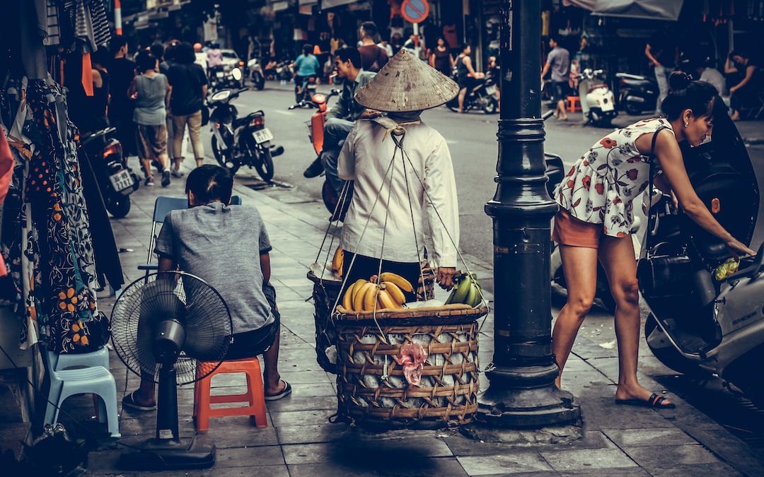 person carrying fruit baskets