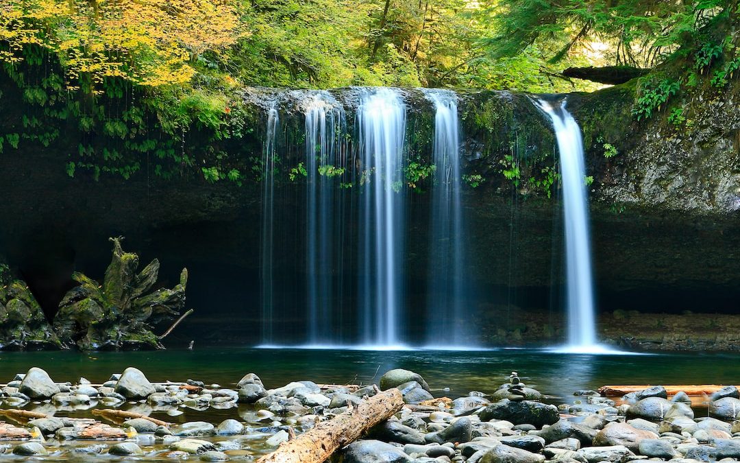 long-exposure photo of lake with waterfall at daytime