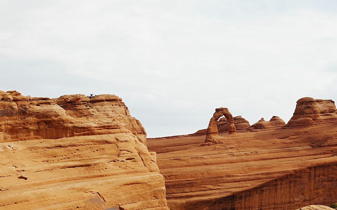 brown rock formation under white sky during daytime