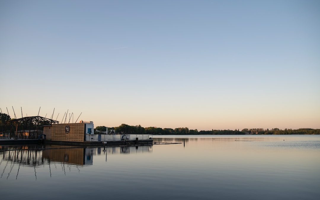 brown wooden house on water during daytime