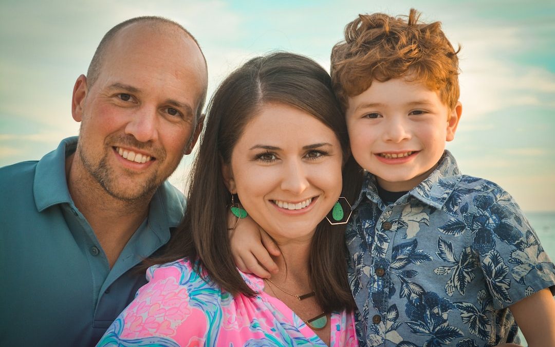 man in blue and white floral button up shirt beside woman in pink and white floral