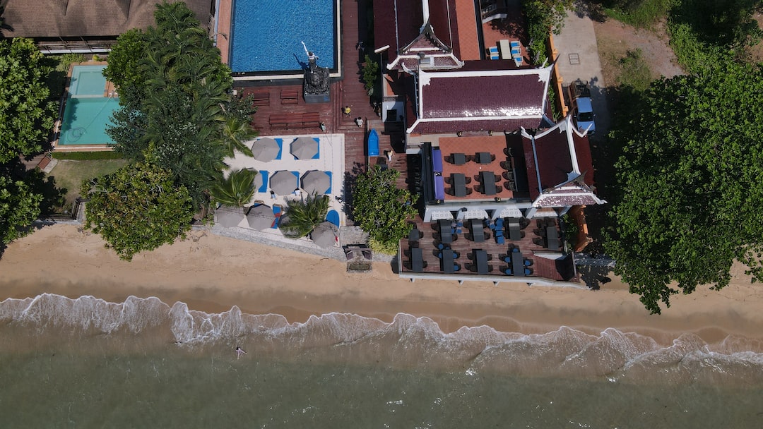 an aerial view of a beach resort with a pool