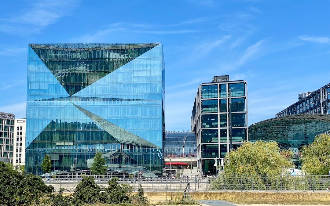 a large glass building sitting in the middle of a park