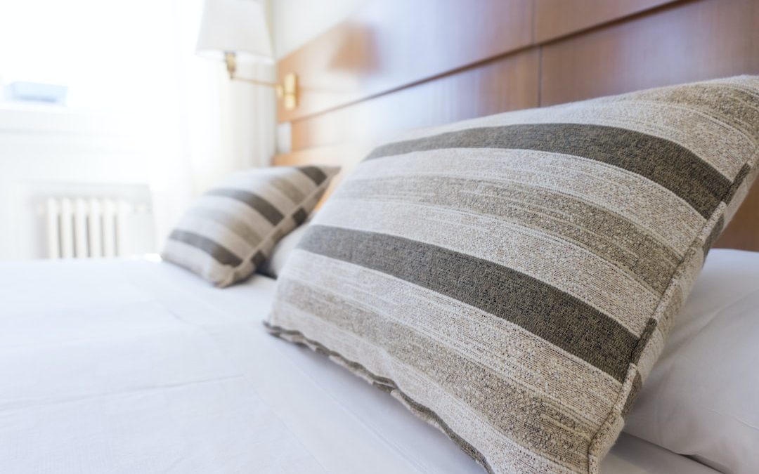 gray and black throw pillow on bed