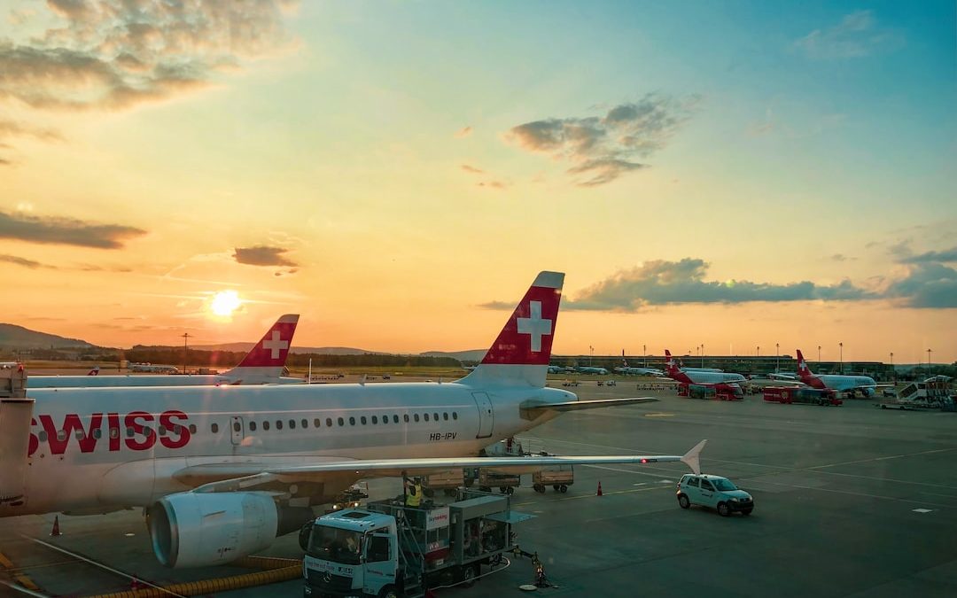 white and red airplane on airport during daytime