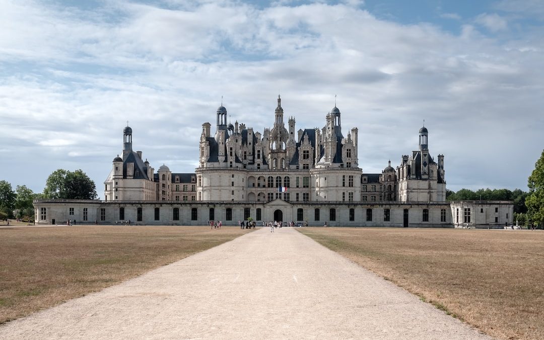 a large castle with a long driveway leading to it