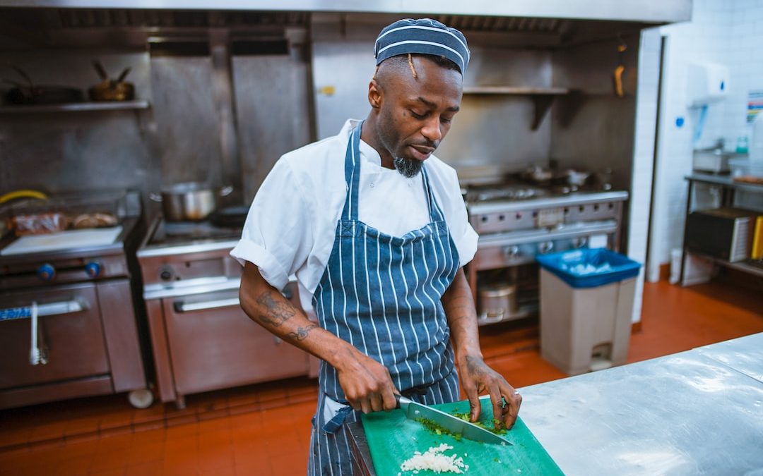 man chopping garlic gloves