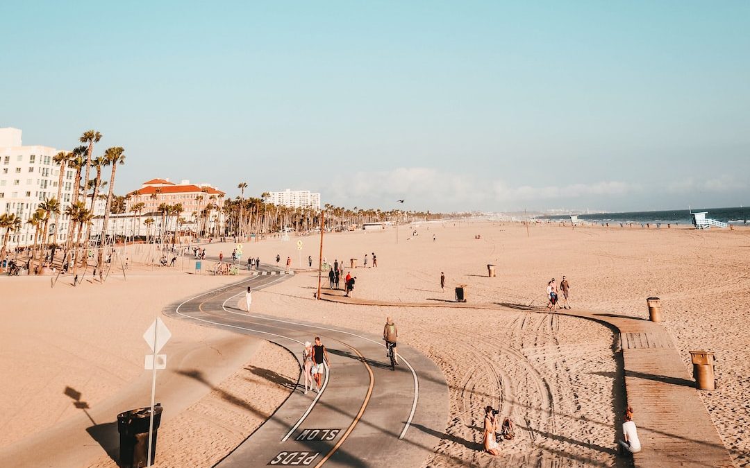 people on road and sand