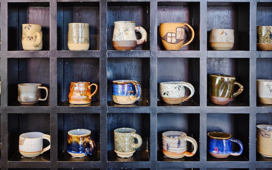 assorted-color mugs on rack