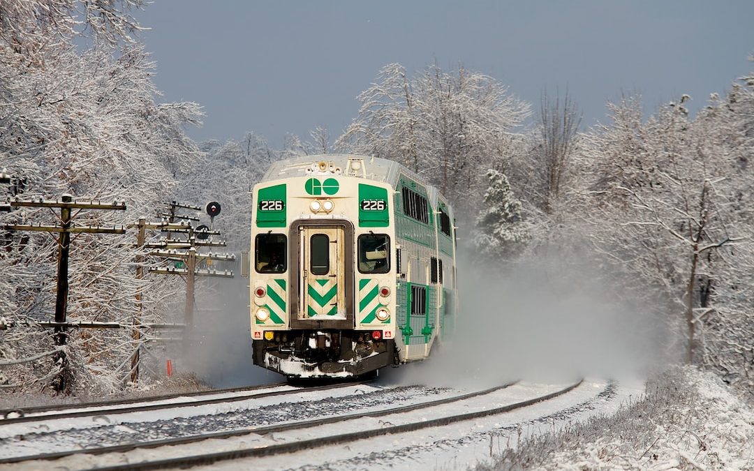 white and green train on railway during daytime