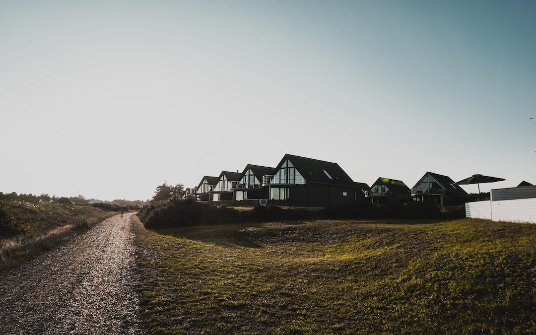 white and black house on green grass field during daytime