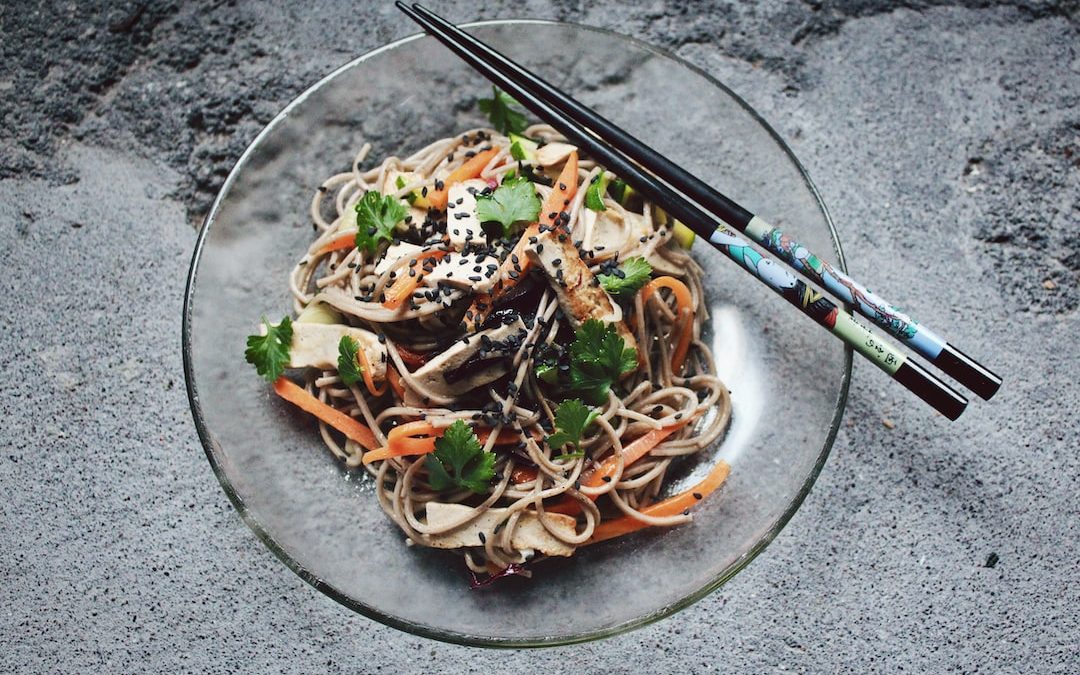 vegetable noodle with chopstick on glass plate