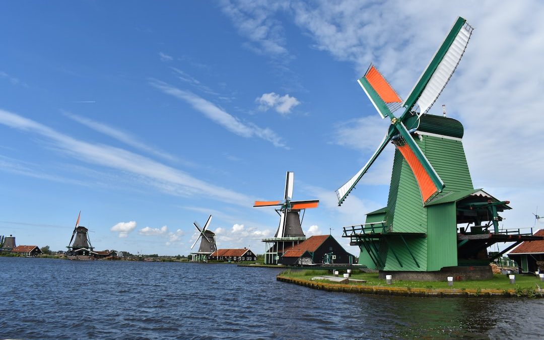 a group of windmills sitting next to a body of water