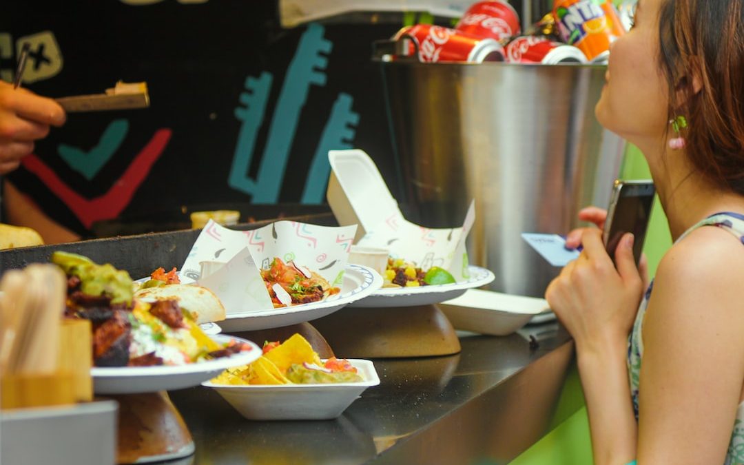 person holding white ceramic bowl with food