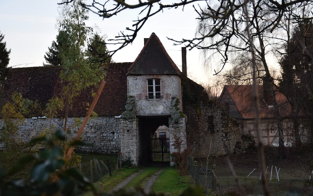 an old building with a tower and a gate