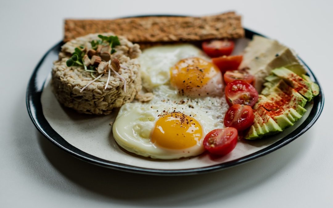 sliced bread with egg and vegetable on white ceramic plate