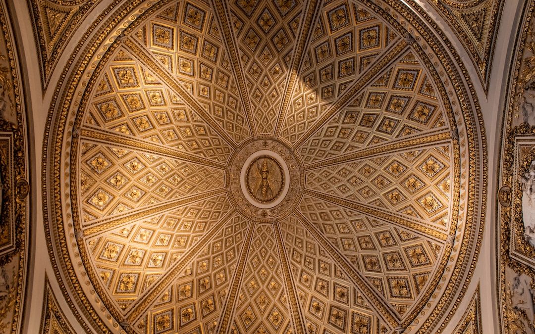 a ceiling in a building with a clock on it