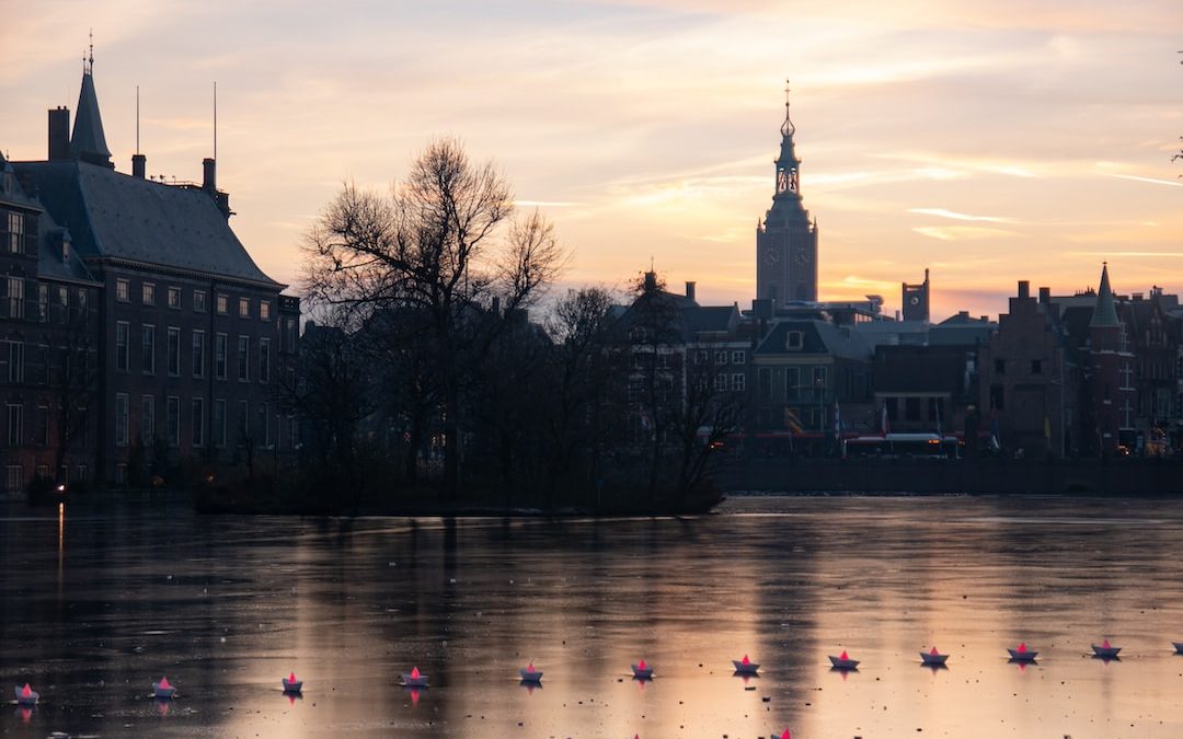 a body of water surrounded by buildings and a clock tower