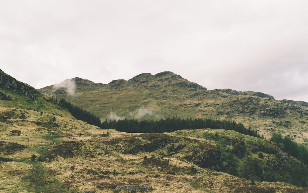 green mountain under cloudy sky