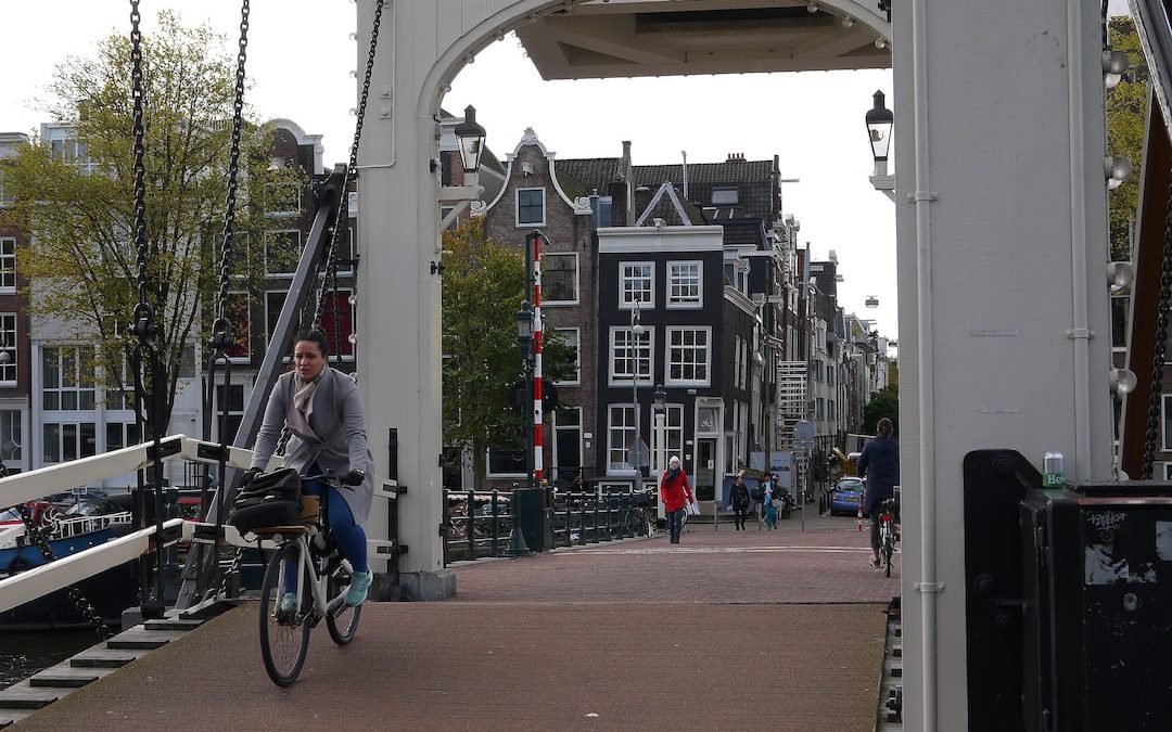 a man riding a bike across a bridge