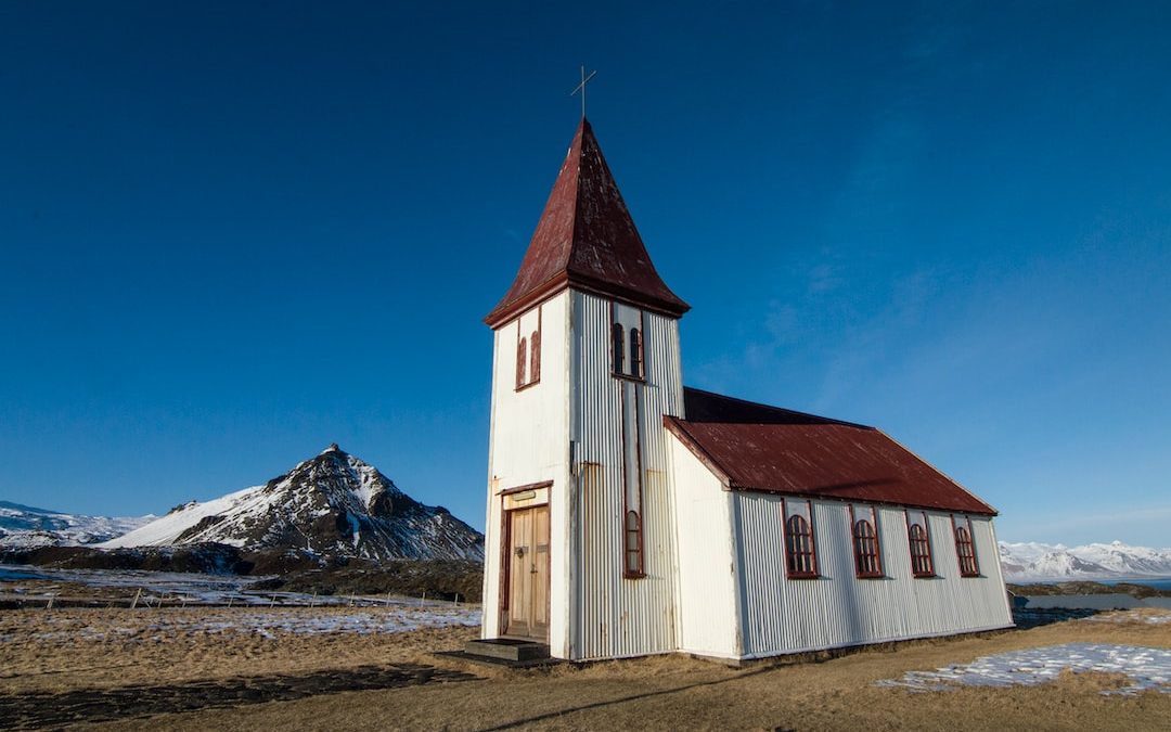 photo of white and brown concrete house near mountain