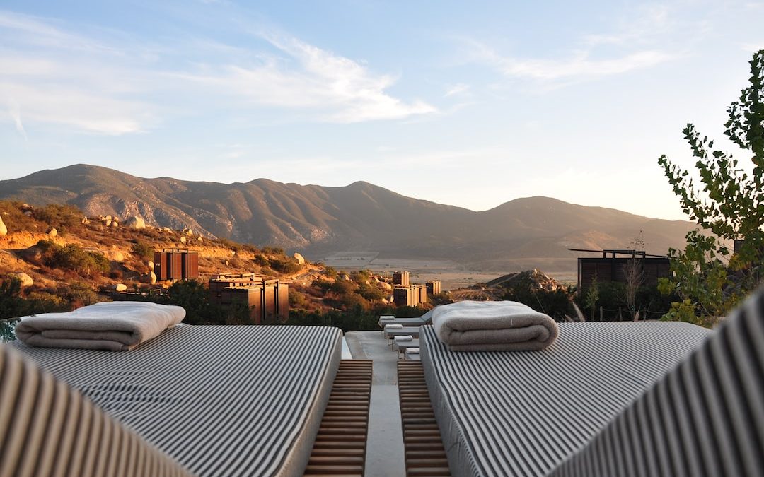 sunloungers fronting buildings near mountain