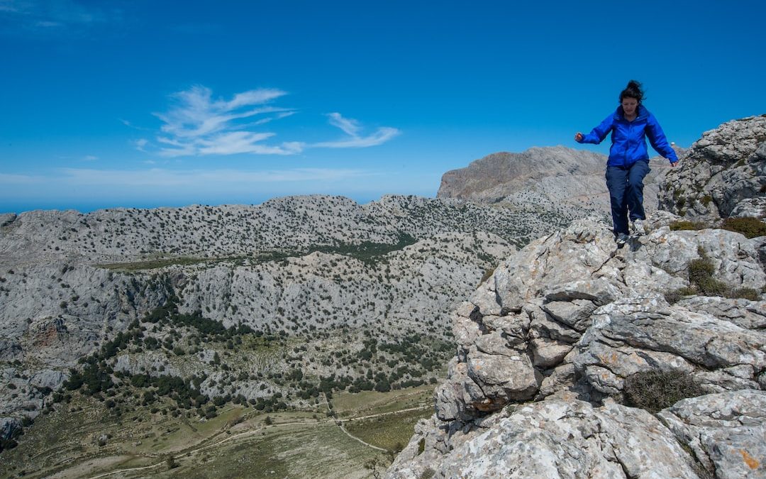 a man standing on a rocky hill