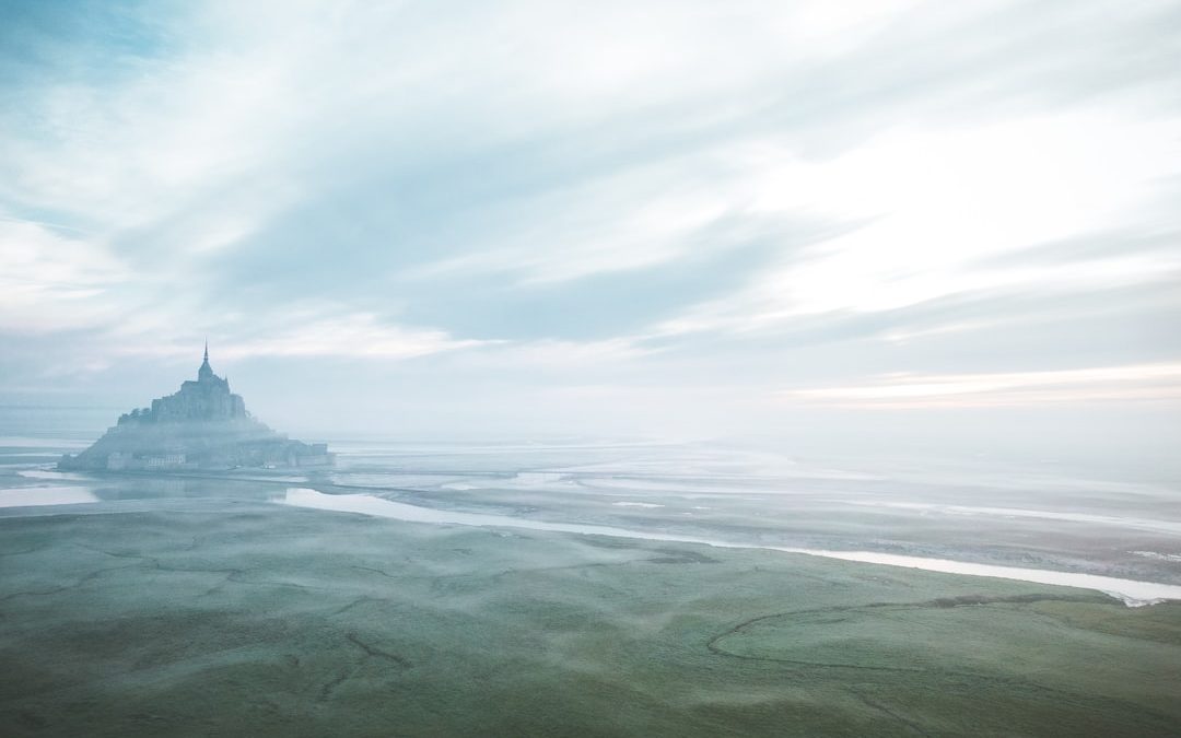 body of water under cloudy sky during daytime