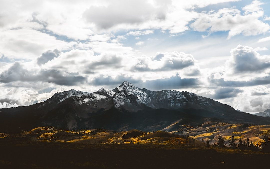 silhouette of mountain under white sky