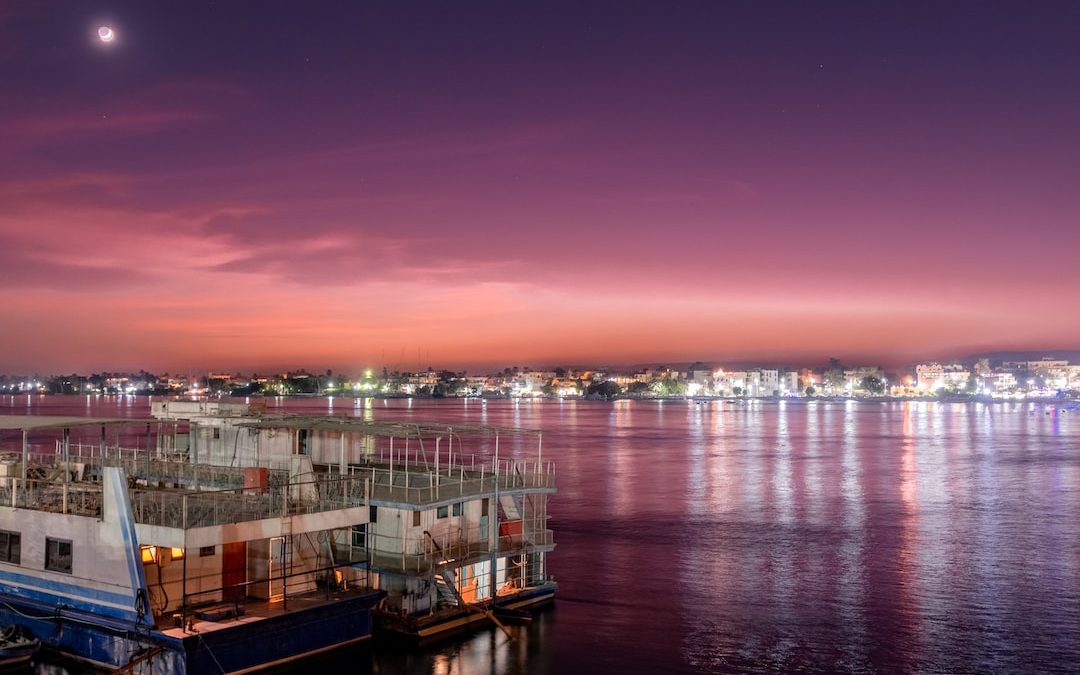 white and brown boat on sea during sunset