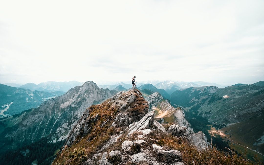 person standing on mountain during daytime