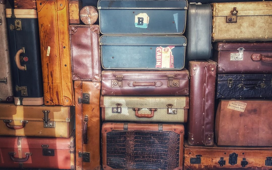 low light photography of stacked luggage