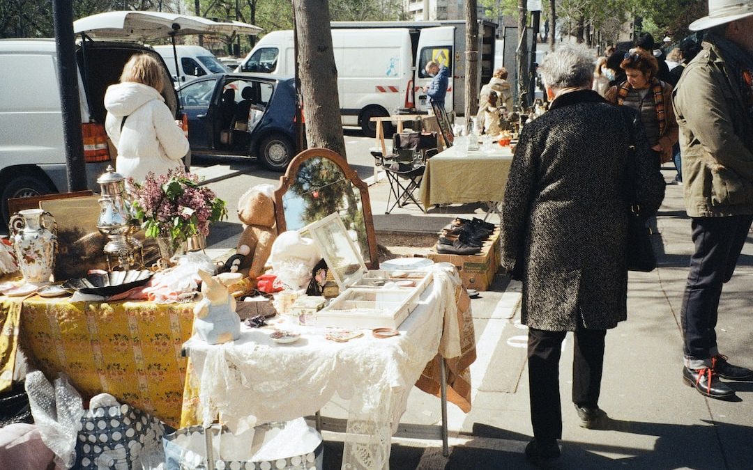 a woman standing next to a table with a mirror on it