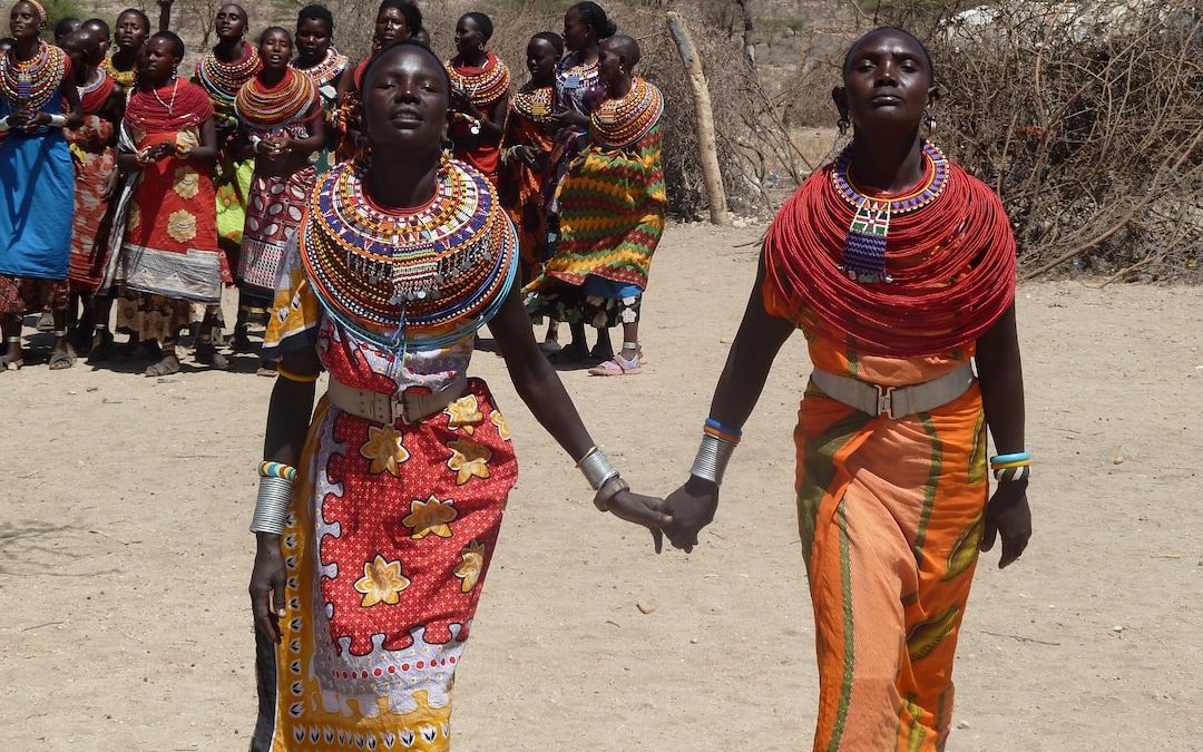 two women holding hands each other