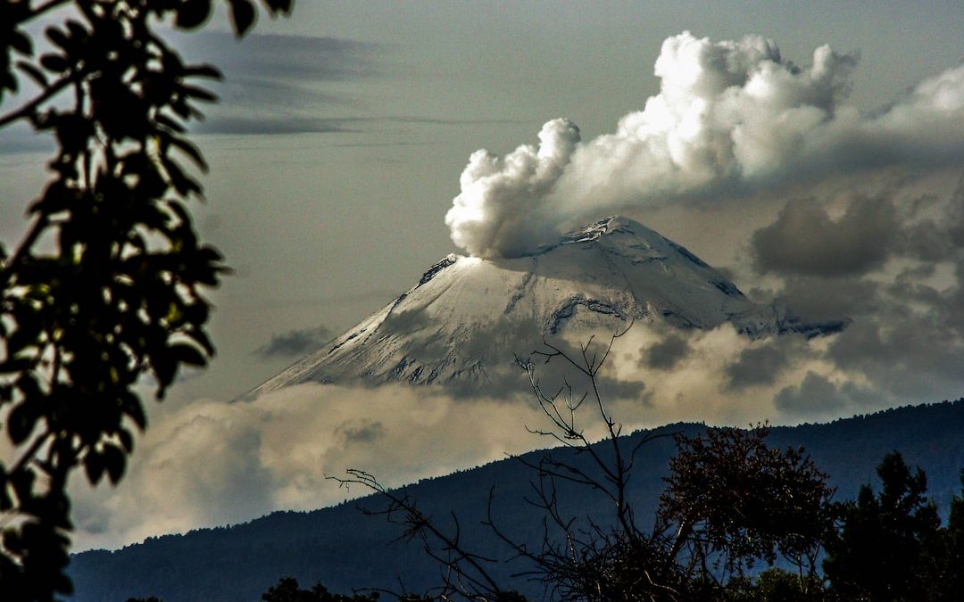 time lapse photography of mountain with smoke on its mouth