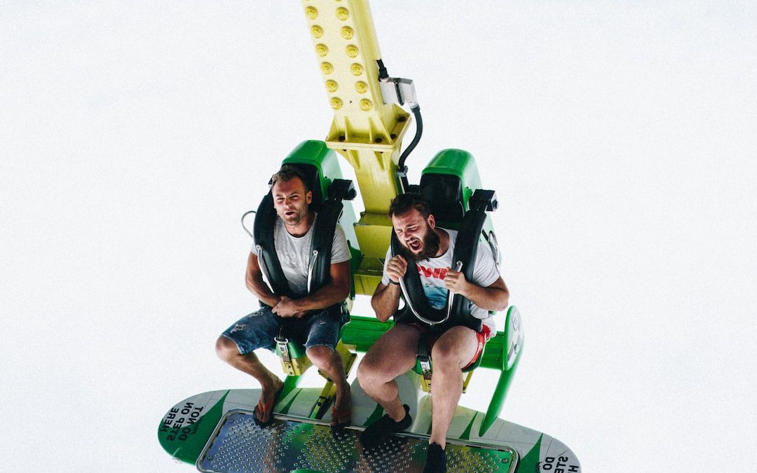 two men riding amusement ride