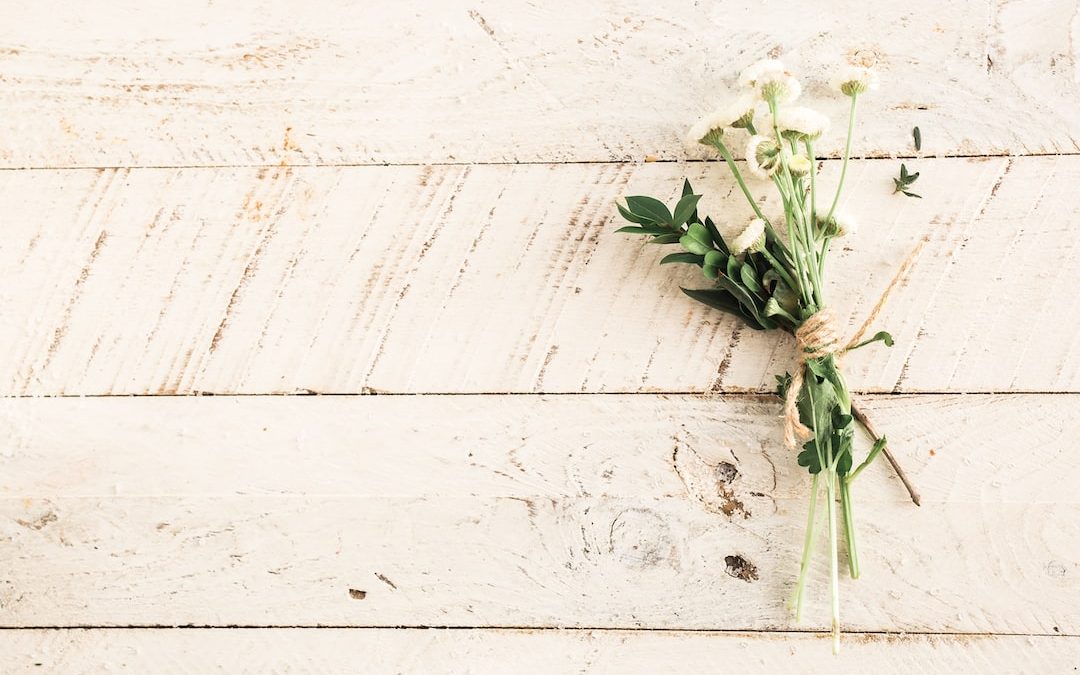 white flower bouquet on wooden surface