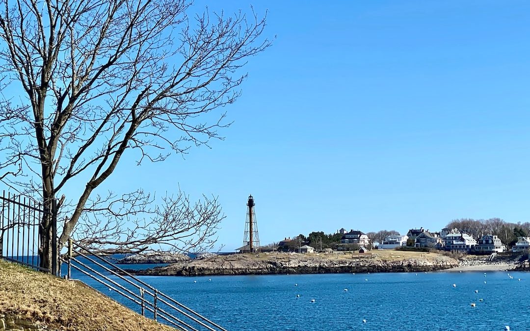 a view of a body of water with a lighthouse in the background