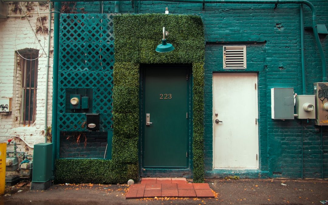 a green door next to a building