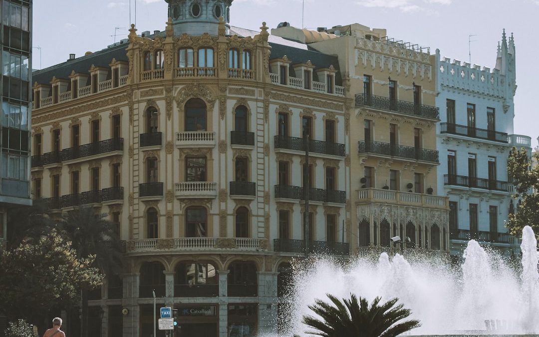 a large building with a fountain in front of it