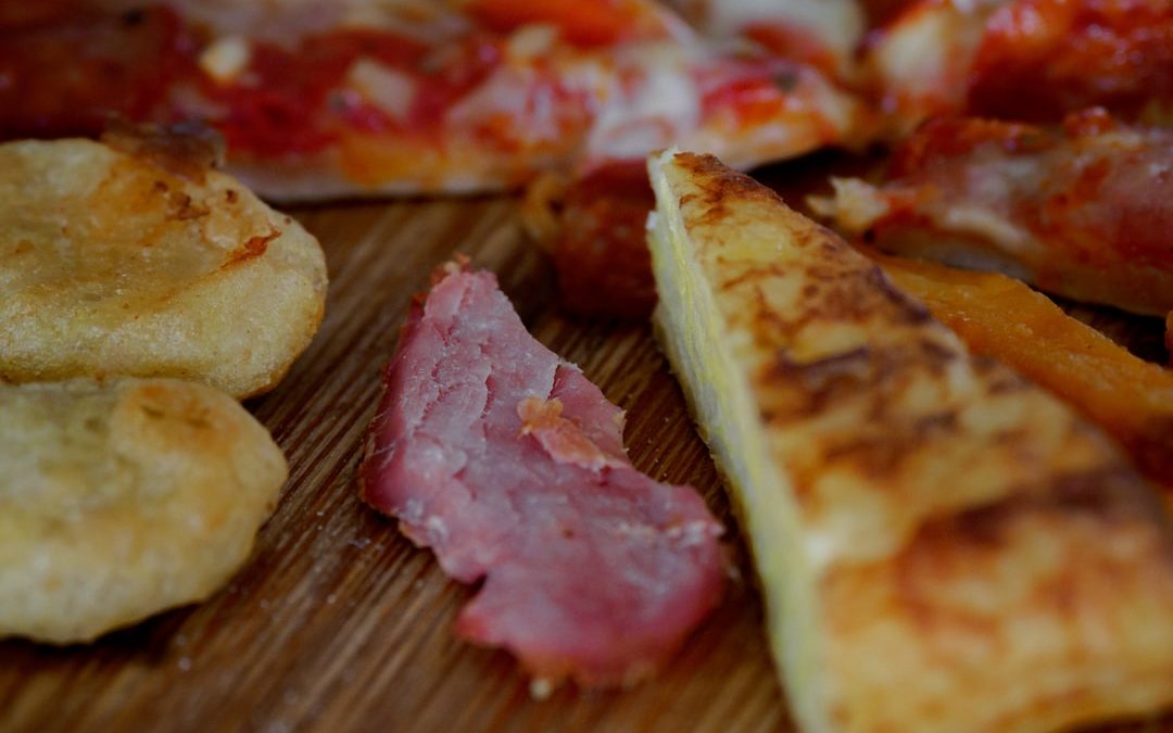 sliced pizza on brown wooden table