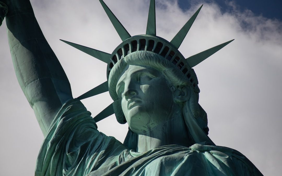 statue of liberty under cloudy sky during daytime