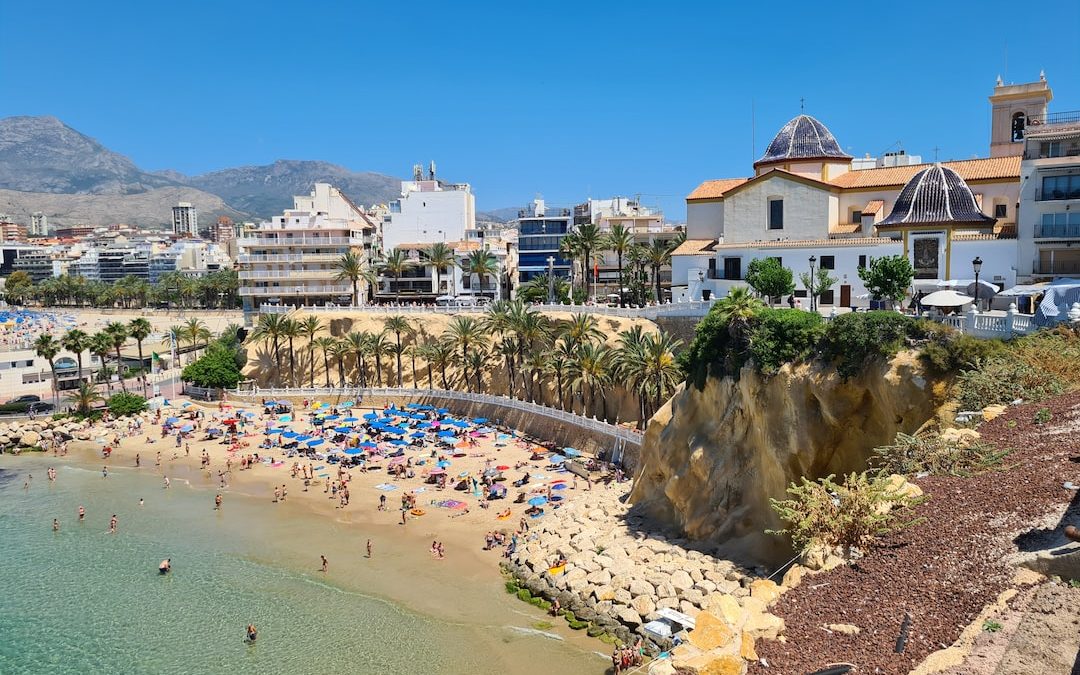 a beach with people and buildings