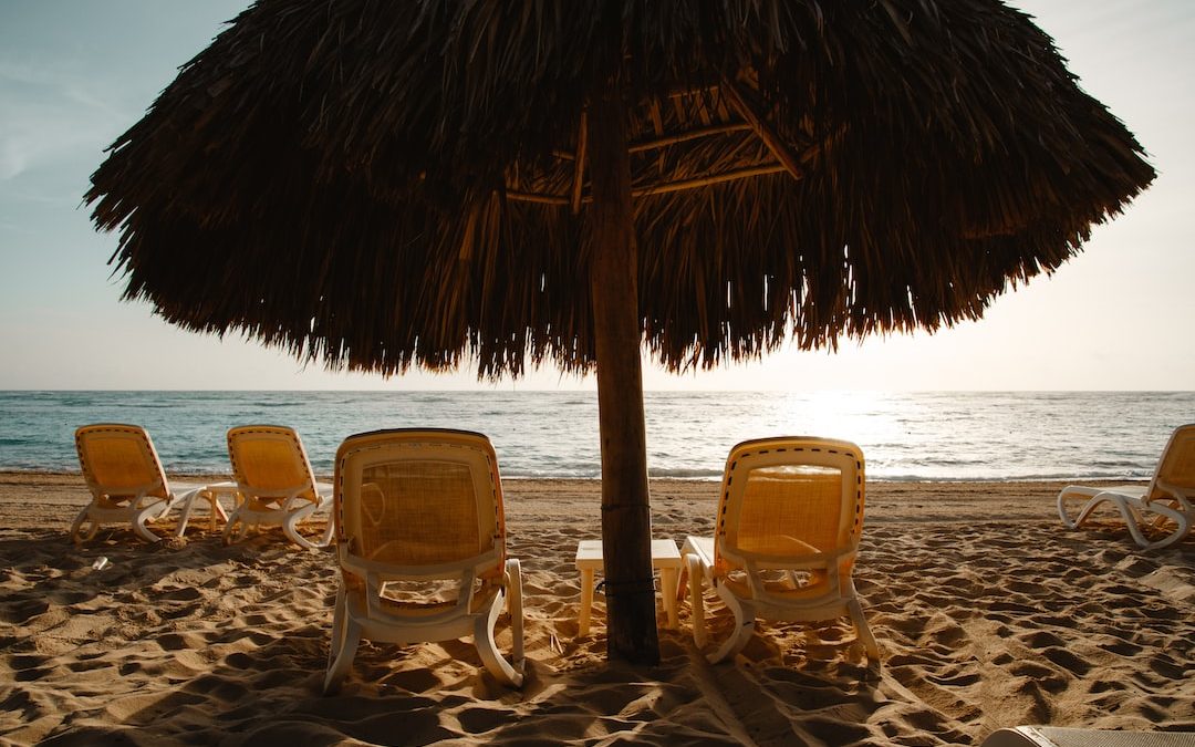 two yellow adirondack chairs under hut