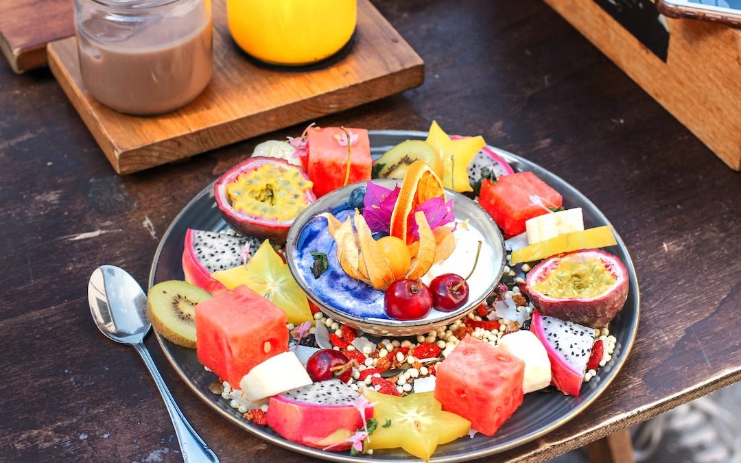 slice of fruits on plate with spoon