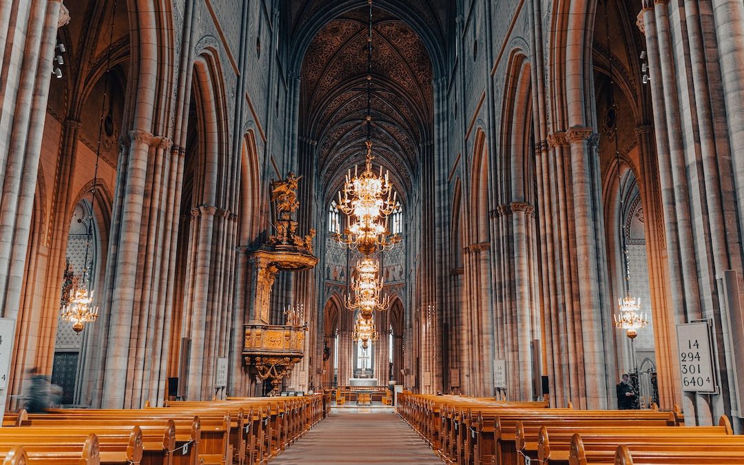 a large cathedral with a chandelier hanging from the ceiling