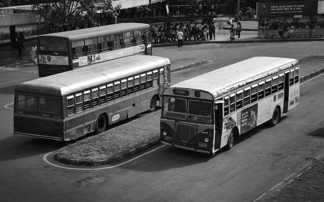 a couple of buses parked next to each other on a street