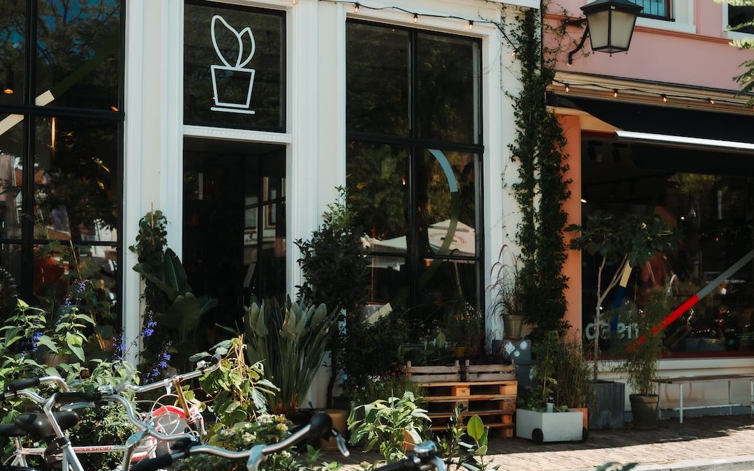 a building with plants and bikes outside